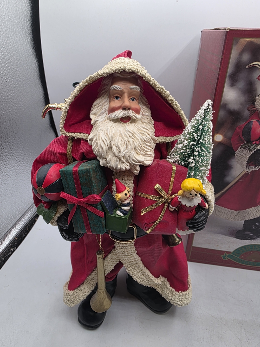 Clothtique Santa Claus Large 10.5” Holding Gifts & Bottle Brush Tree